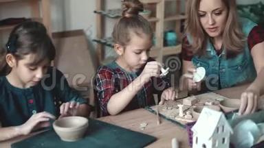 陶艺课。孩子们热衷于用粘土塑造。妈妈和两个女儿在一起创作